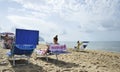 Women on the beach relaxing by reading gossip magazines.